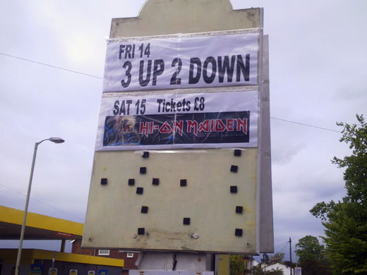 Huge billboard, tiny poster. Big Sign